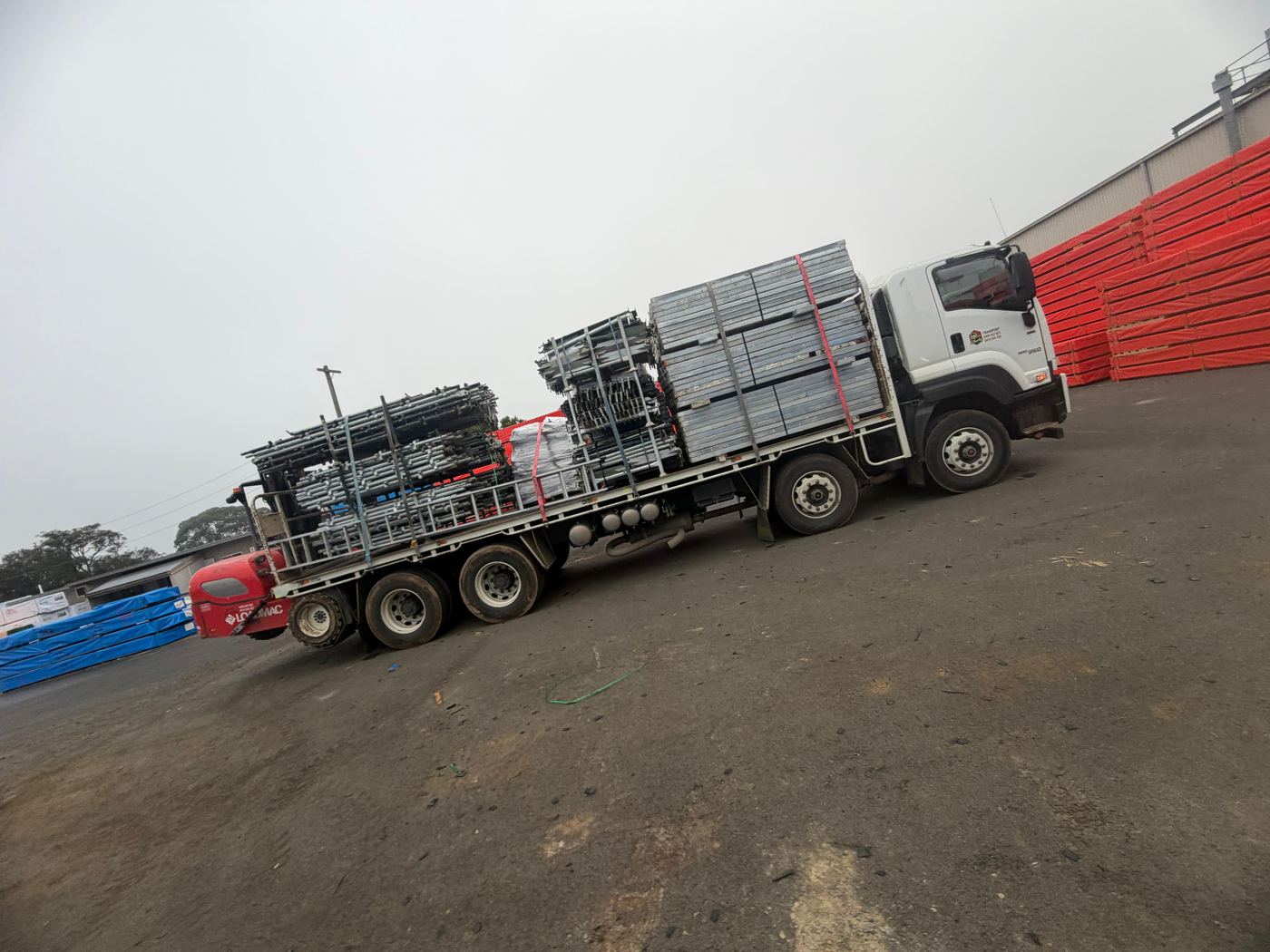 Liberty Transport truck loaded with scaffolding frames and Loadmac forklift — Melbourne scaffolding delivery